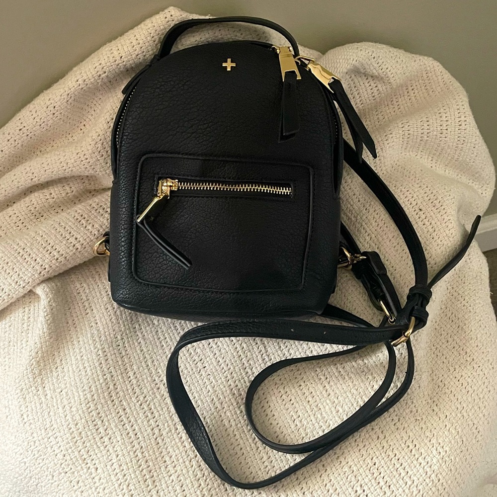 PETA +JAIN mini black and gold back pack with adjustable straps.